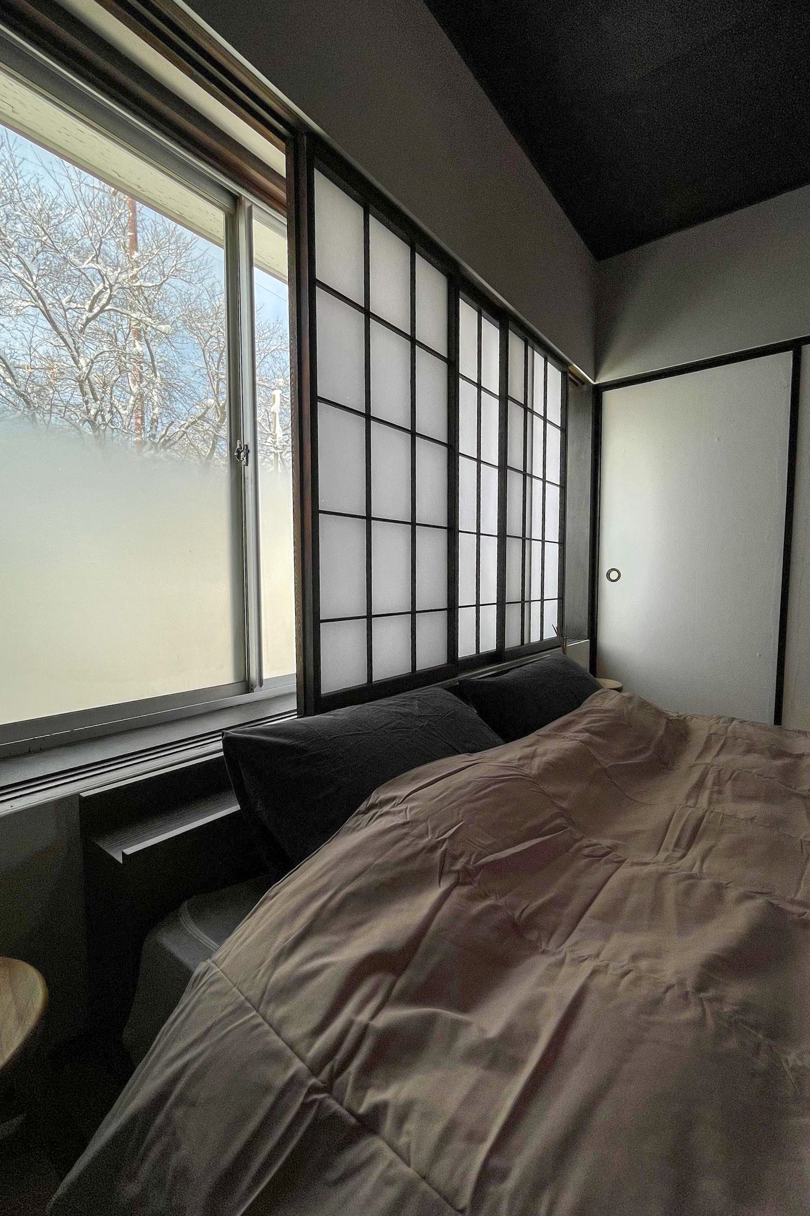 "Newly Renovated Traditional Japanese-style bedroom with a Western flooring and shoji screen windows"
